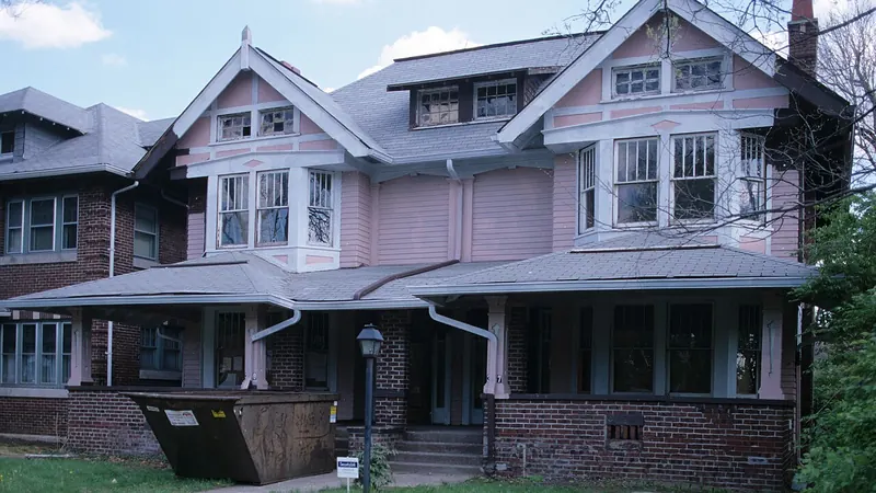 Older twin houses with front porches and gabled roofs