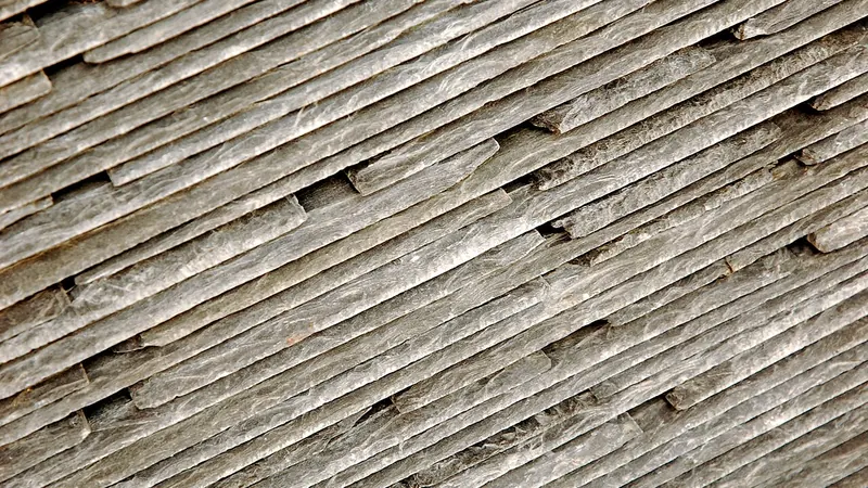 Close-up of worn, weathered slate roof tiles