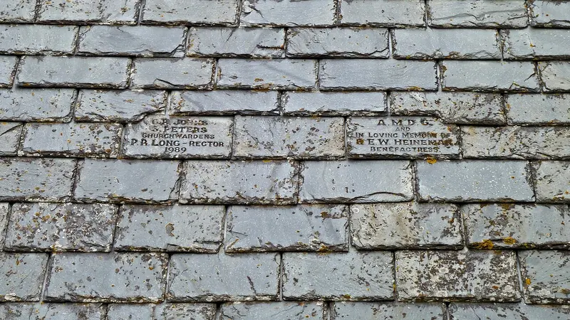 Weathered gray slate roof tiles in overlapping rows